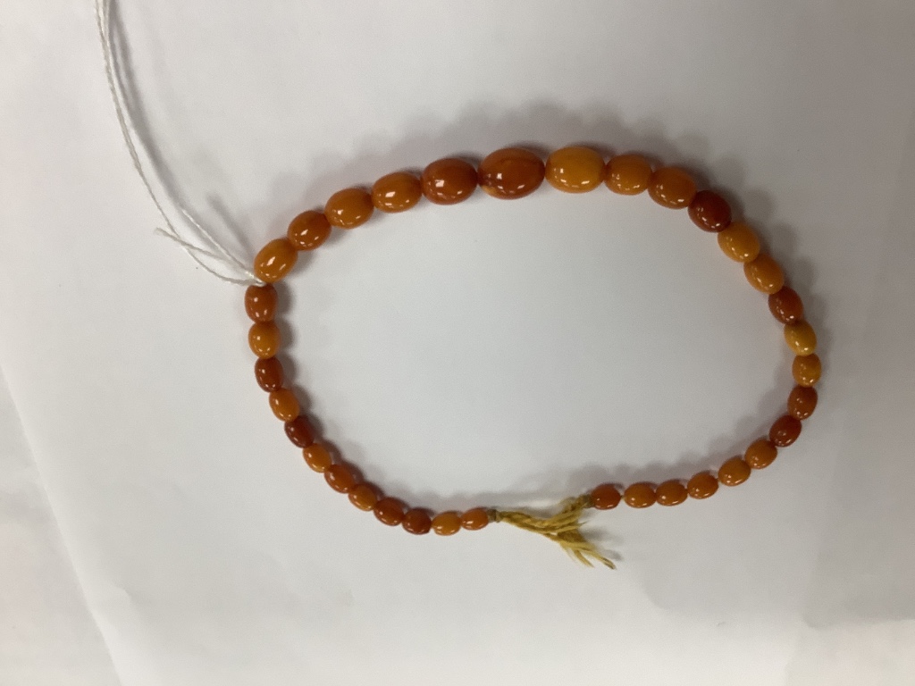 A small quantity of assorted costume jewellery including amber necklace.